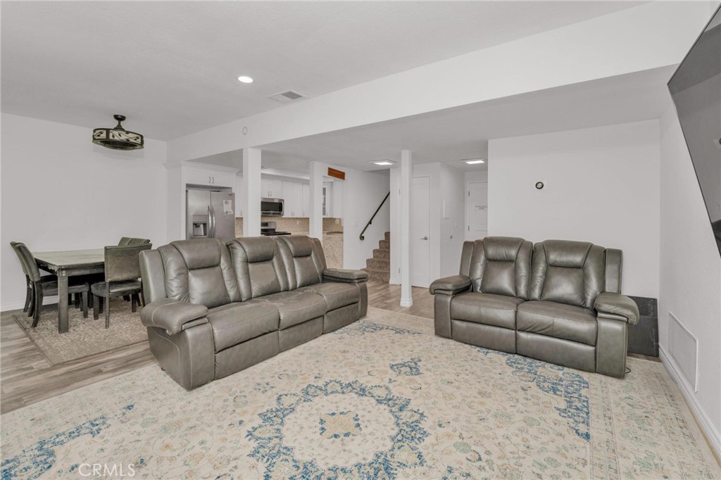 646 Sycamore Avenue, Unit 18 Claremont, CA 91711 - Photo 26 of 46 a living room with furniture and a dining table with kitchen view
