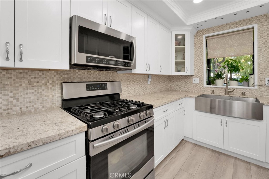 646 Sycamore Avenue, Unit 18 Claremont, CA 91711 - Photo 28 of 46 a kitchen with granite countertop a sink stainless steel appliances and cabinets