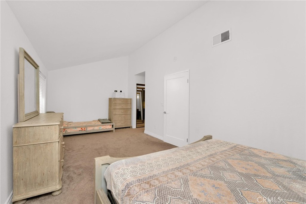 646 Sycamore Avenue, Unit 18 Claremont, CA 91711 - Photo 30 of 46 a bedroom with a bed and a refrigerator
