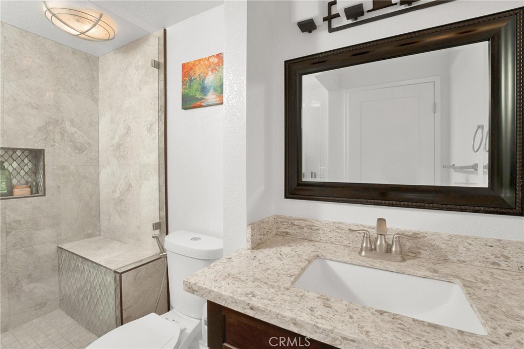 646 Sycamore Avenue, Unit 18 Claremont, CA 91711 - Photo 40 of 46 a bathroom with a granite countertop sink a mirror and a toilet