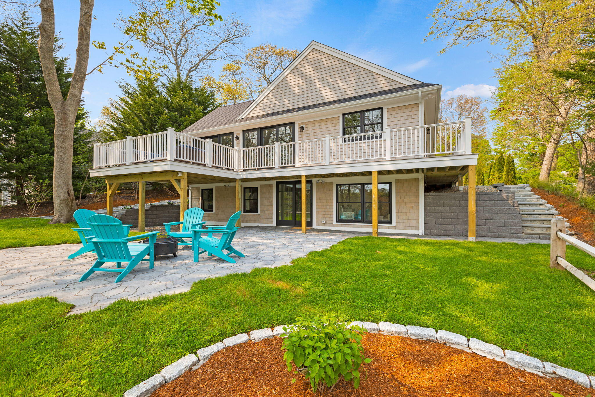 a front view of a house with garden and porch