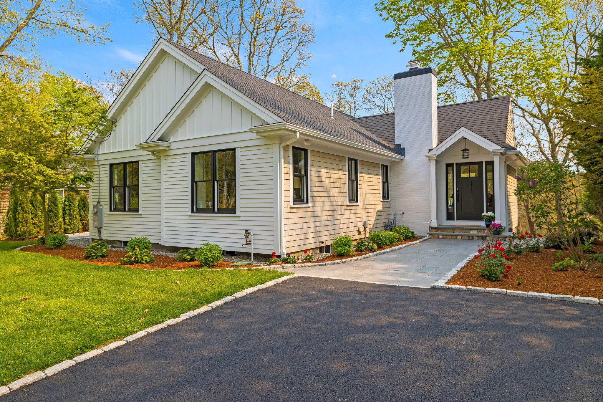 321 Tower Hill Road Osterville, MA 02655 - Photo 2 of 38 a front view of a house with a yard and garage