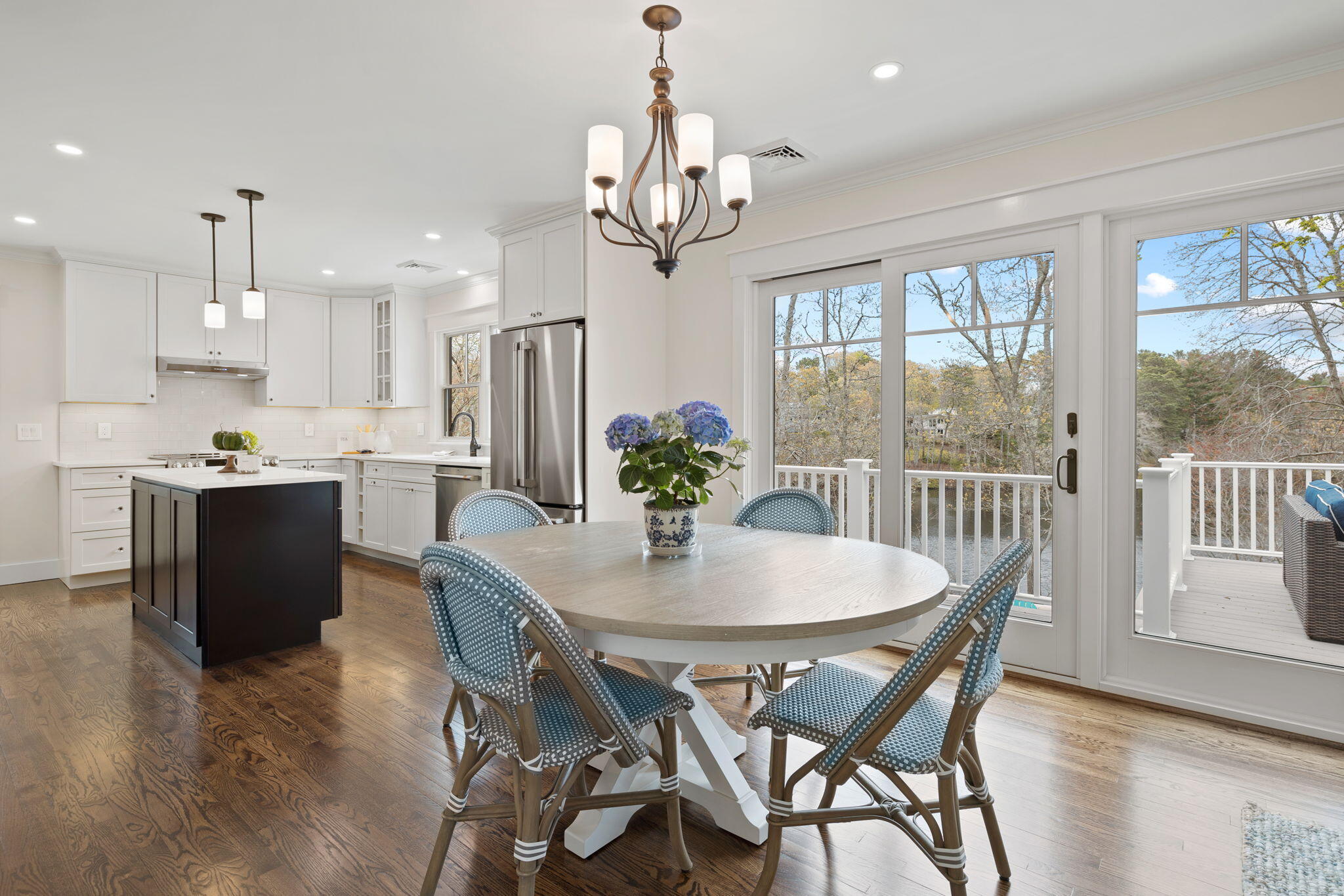 321 Tower Hill Road Osterville, MA 02655 - Photo 8 of 38 a dining room filled chandelier and wooden floor