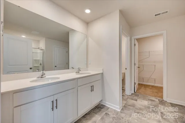 a bathroom with a double vanity sink mirror and double