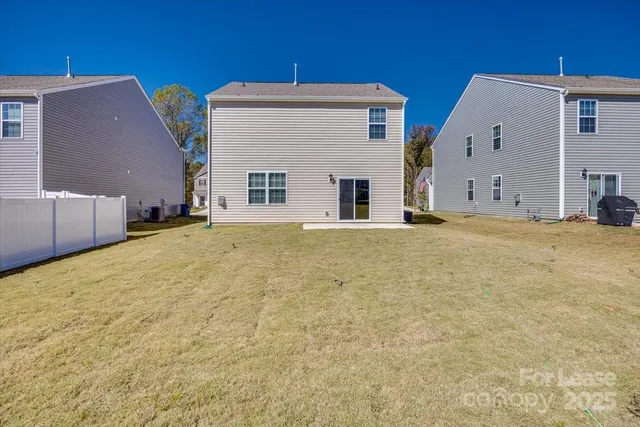 a view of an white house with a yard