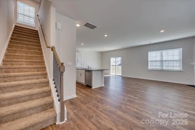 a view of entryway and hall with wooden floor