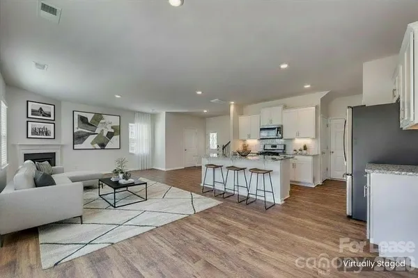 a open kitchen with white cabinets and stainless steel appliances