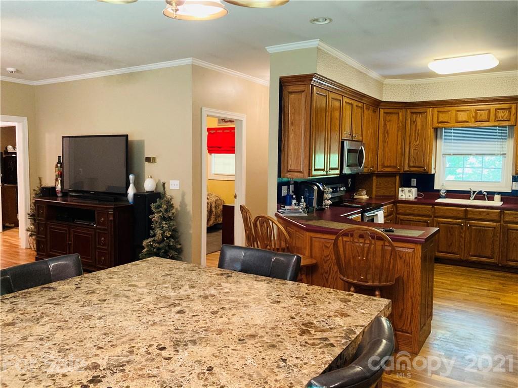 470 Duncard Church Road Rutherfordton, NC 28139 - Photo 5 of 43 a kitchen with stainless steel appliances kitchen island granite countertop a sink stove and granite counter top