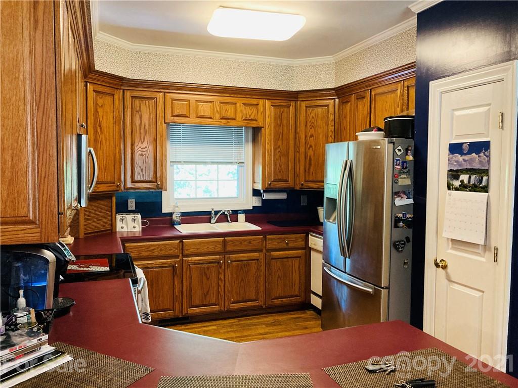470 Duncard Church Road Rutherfordton, NC 28139 - Photo 8 of 43 a kitchen with stainless steel appliances granite countertop a refrigerator a stove and a sink with wooden cabinets