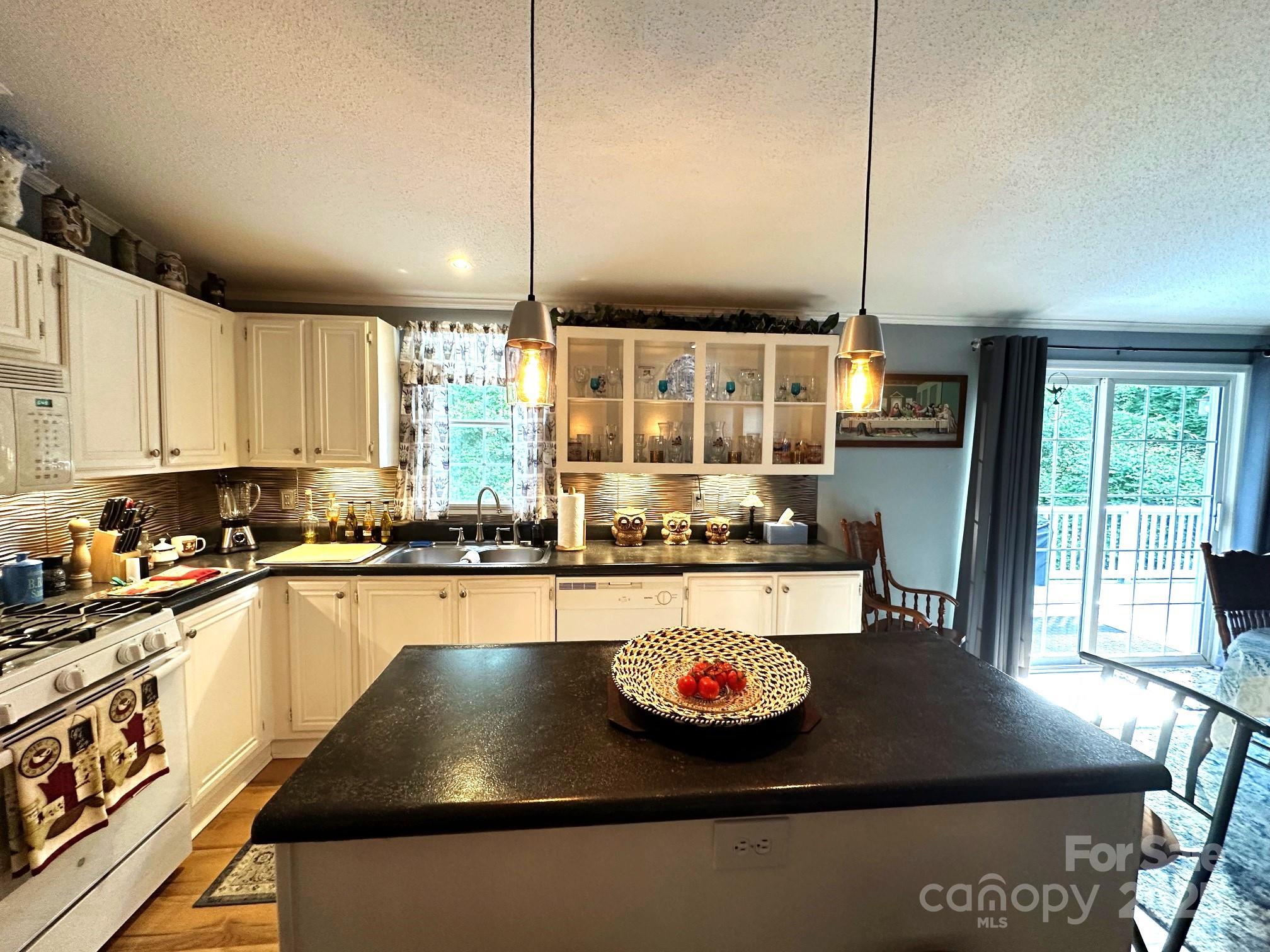 251 Rainbow Rapids Road Rutherfordton, NC 28139 - Photo 20 of 45 a kitchen with stainless steel appliances granite countertop a stove a sink and a microwave