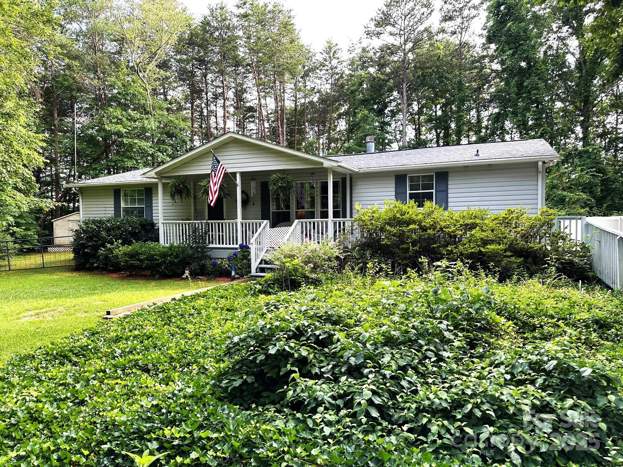251 Rainbow Rapids Road Rutherfordton, NC 28139 - Photo 2 of 45 a front view of a house with garden