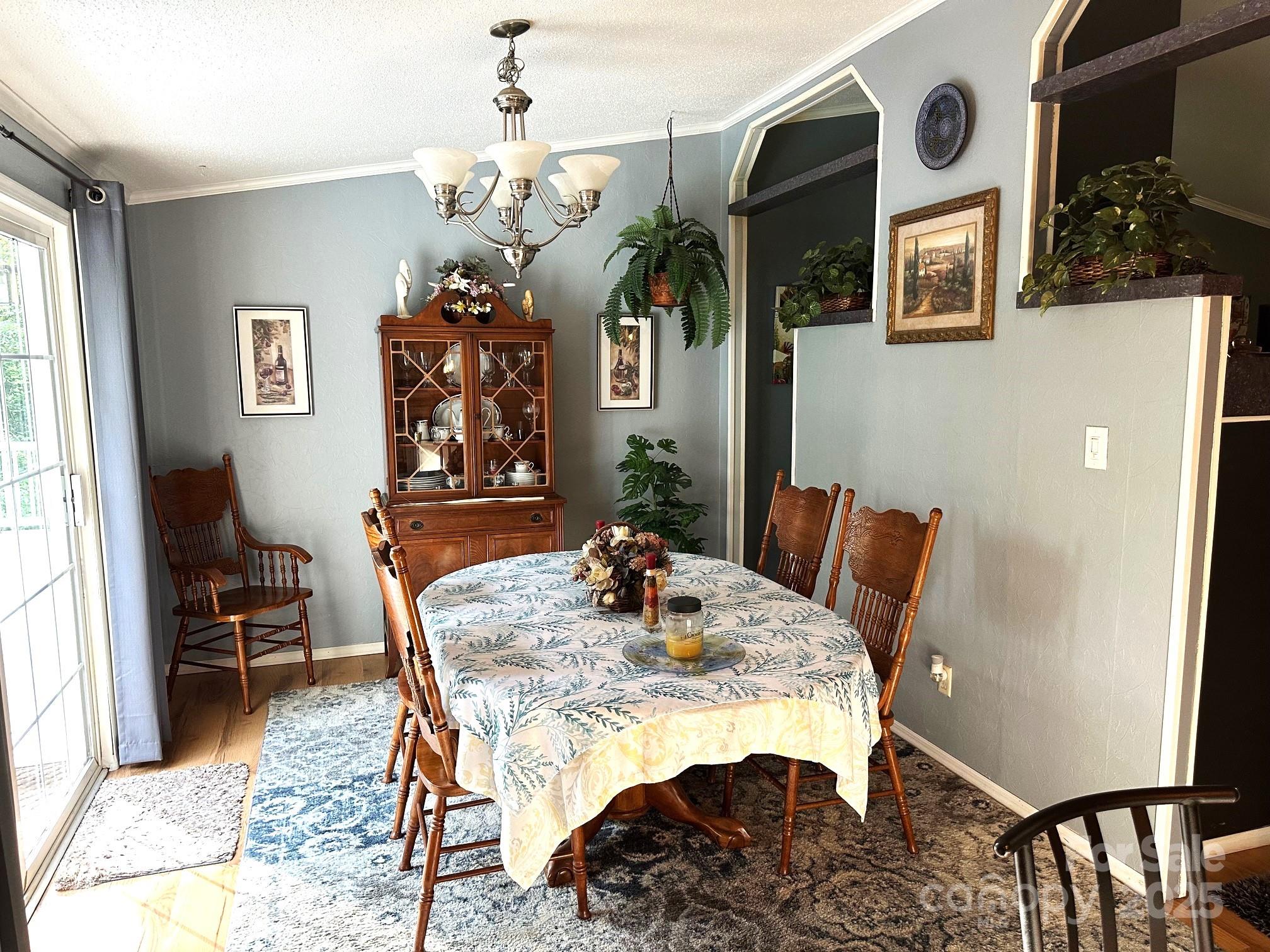 251 Rainbow Rapids Road Rutherfordton, NC 28139 - Photo 24 of 45 a view of a dining room with furniture and a chandelier