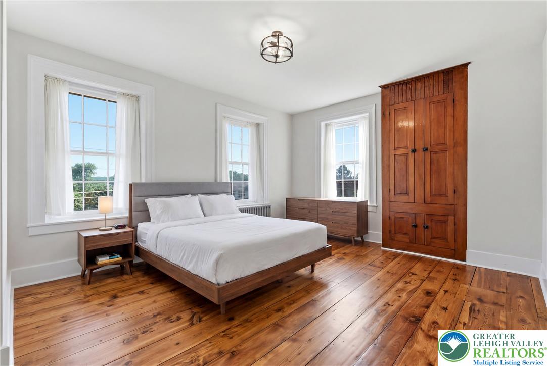 4682 Steuben Road Bethlehem, PA 18020 - Photo 26 of 79 Natural light illuminates the rich hardwood flooring in this inviting sleeping area.