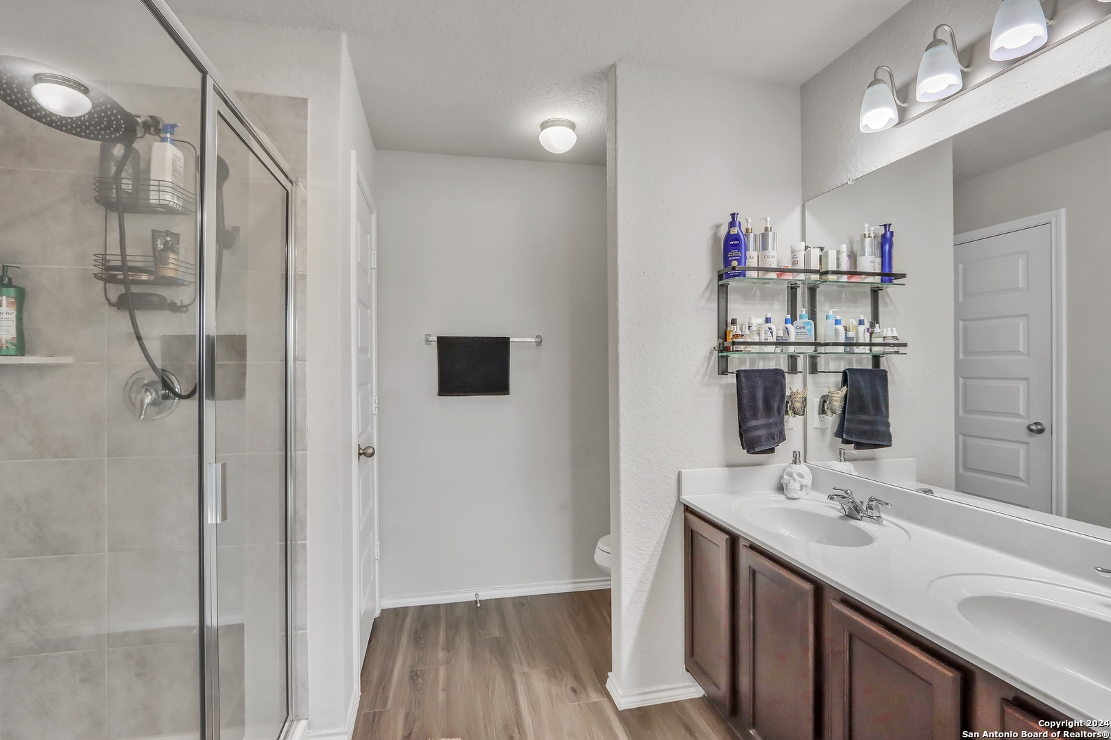 2425 Marty Way Seguin, TX 78155 - Photo 14 of 22 a bathroom with a sink mirror and shower