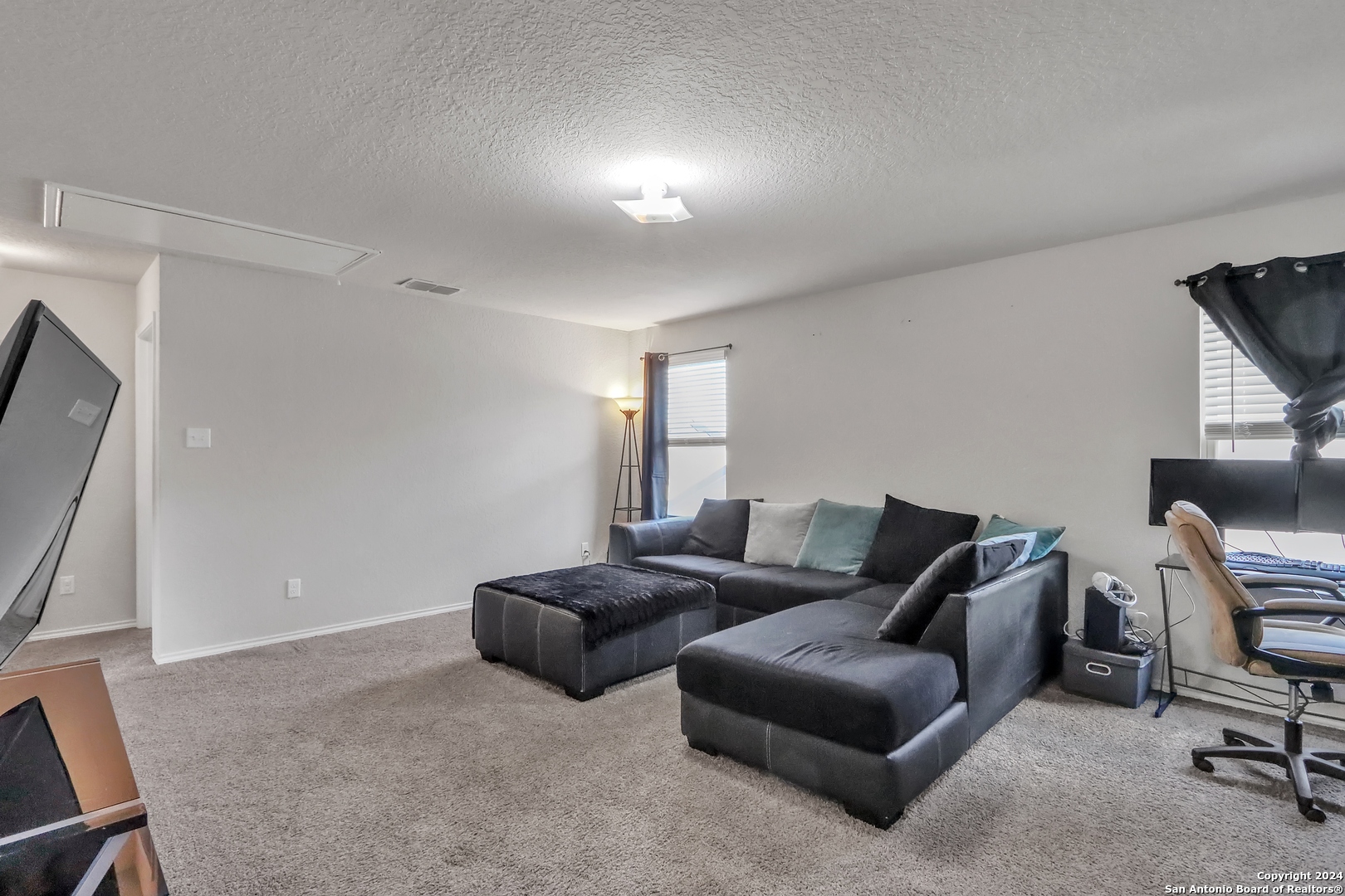 2425 Marty Way Seguin, TX 78155 - Photo 16 of 22 a living room with furniture and a flat screen tv