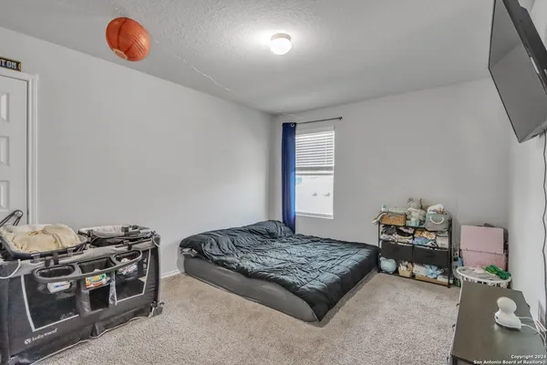 a bedroom with a bed and a chair