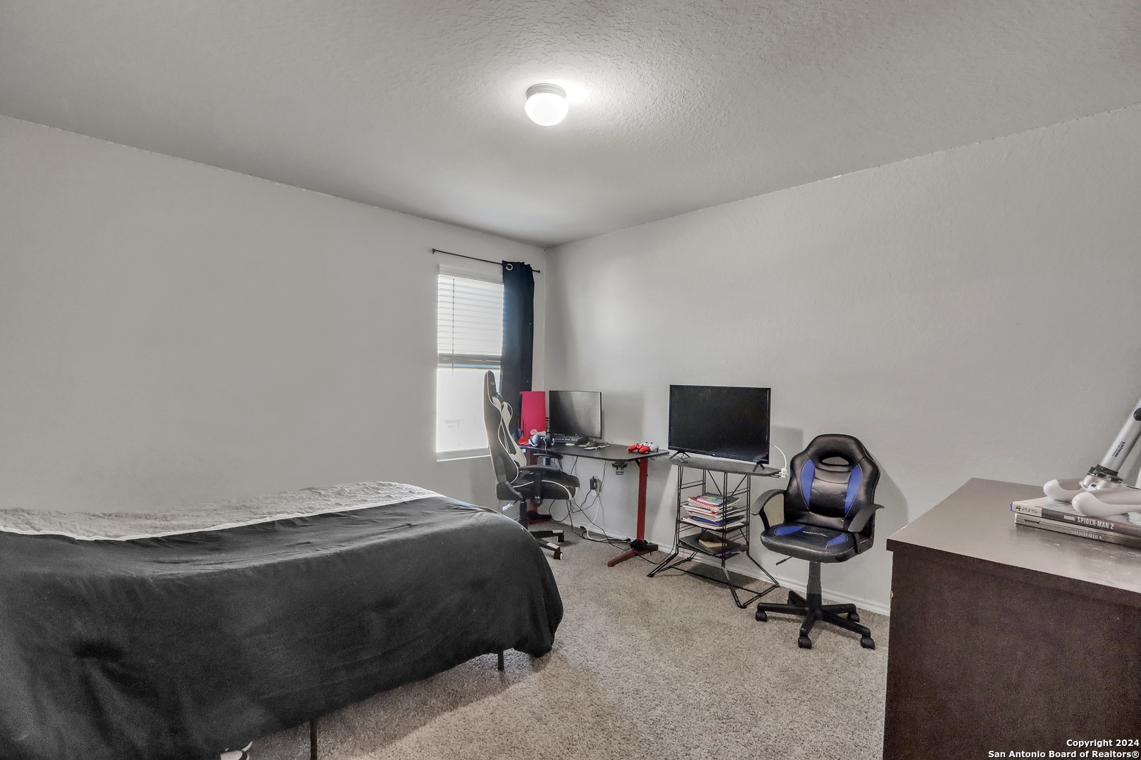 2425 Marty Way Seguin, TX 78155 - Photo 20 of 22 a bedroom with a bed and a chair