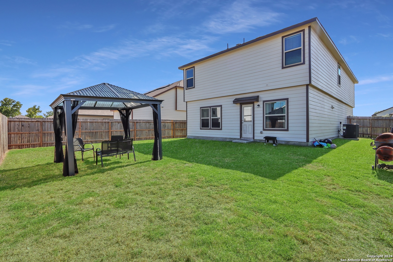 2425 Marty Way Seguin, TX 78155 - Photo 21 of 22 a view of a house with backyard and porch