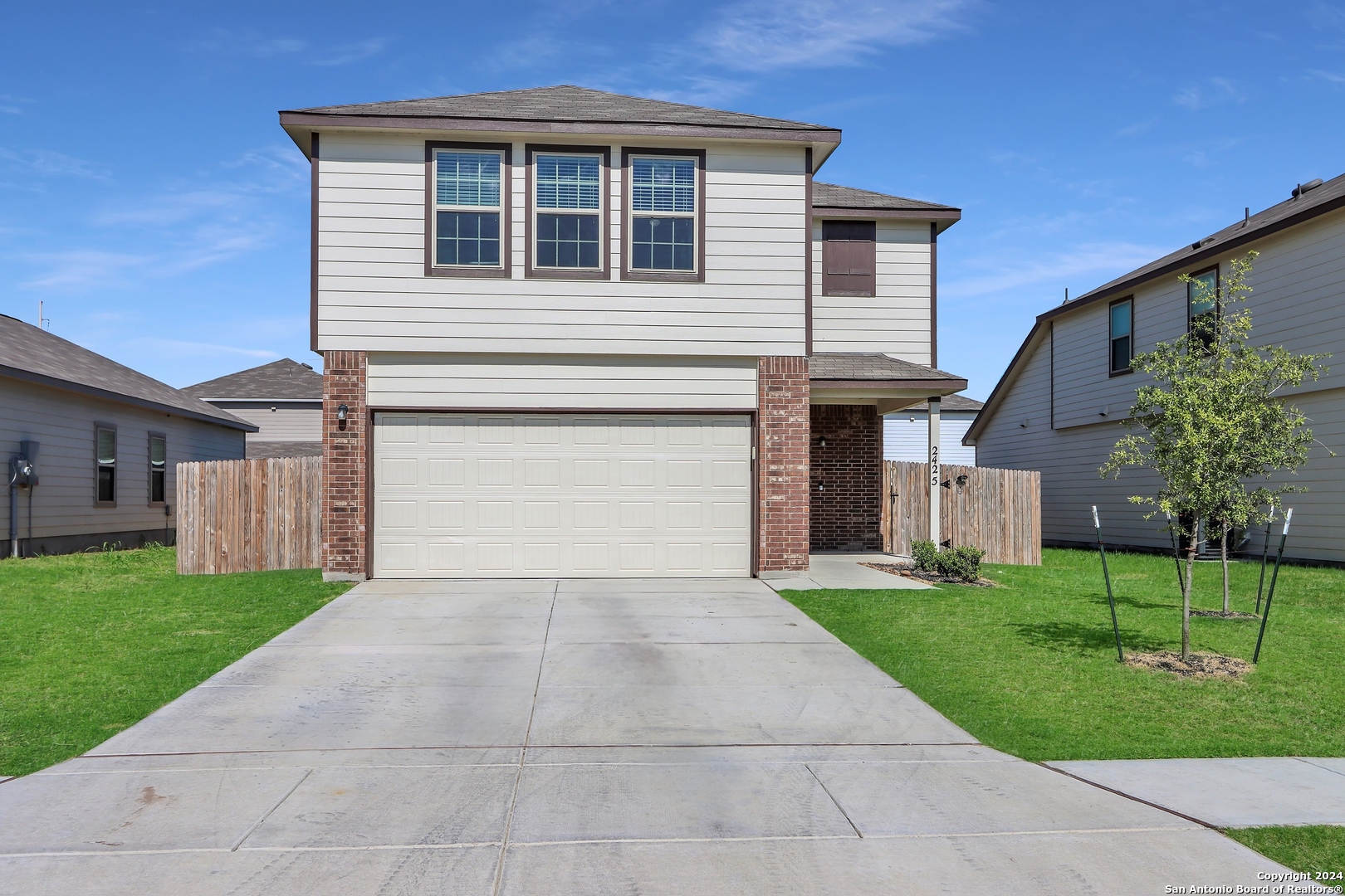 2425 Marty Way Seguin, TX 78155 - Photo 4 of 22 a front view of a house with a garden and yard