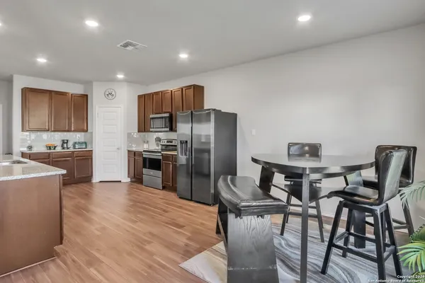 a dining room with furniture and wooden floor