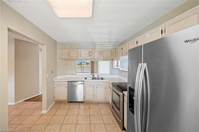 a kitchen with a refrigerator sink and stove