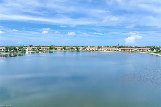 a view of a lake with houses in the back