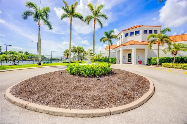 a view of a white house with a yard and plants