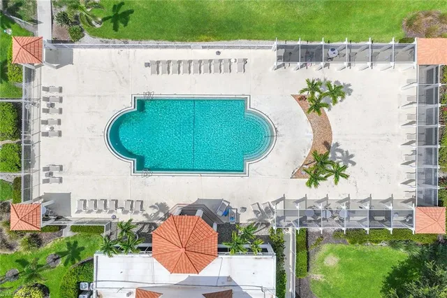 an aerial view of a house with a swimming pool patio and outdoor seating