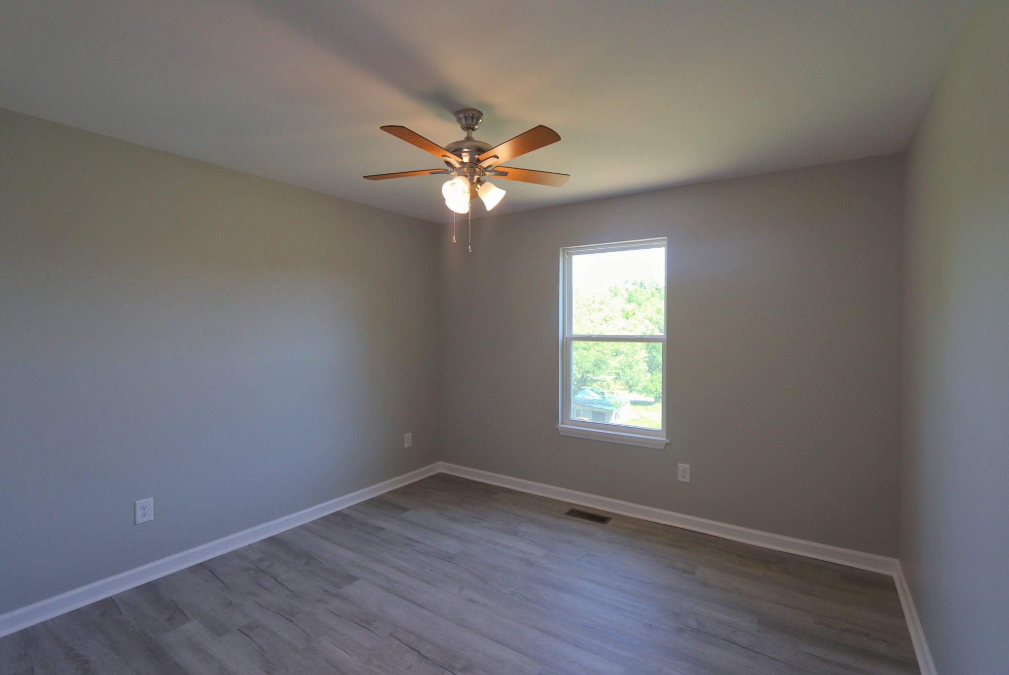 512 Highland Park Road Red Boiling Springs, TN 37150 - Photo 12 of 18 an empty room with a window and a fan