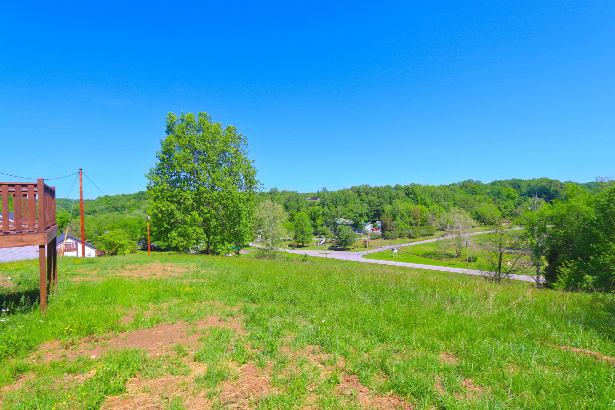 512 Highland Park Road Red Boiling Springs, TN 37150 - Photo 17 of 18 a view of a green field with wooden fence