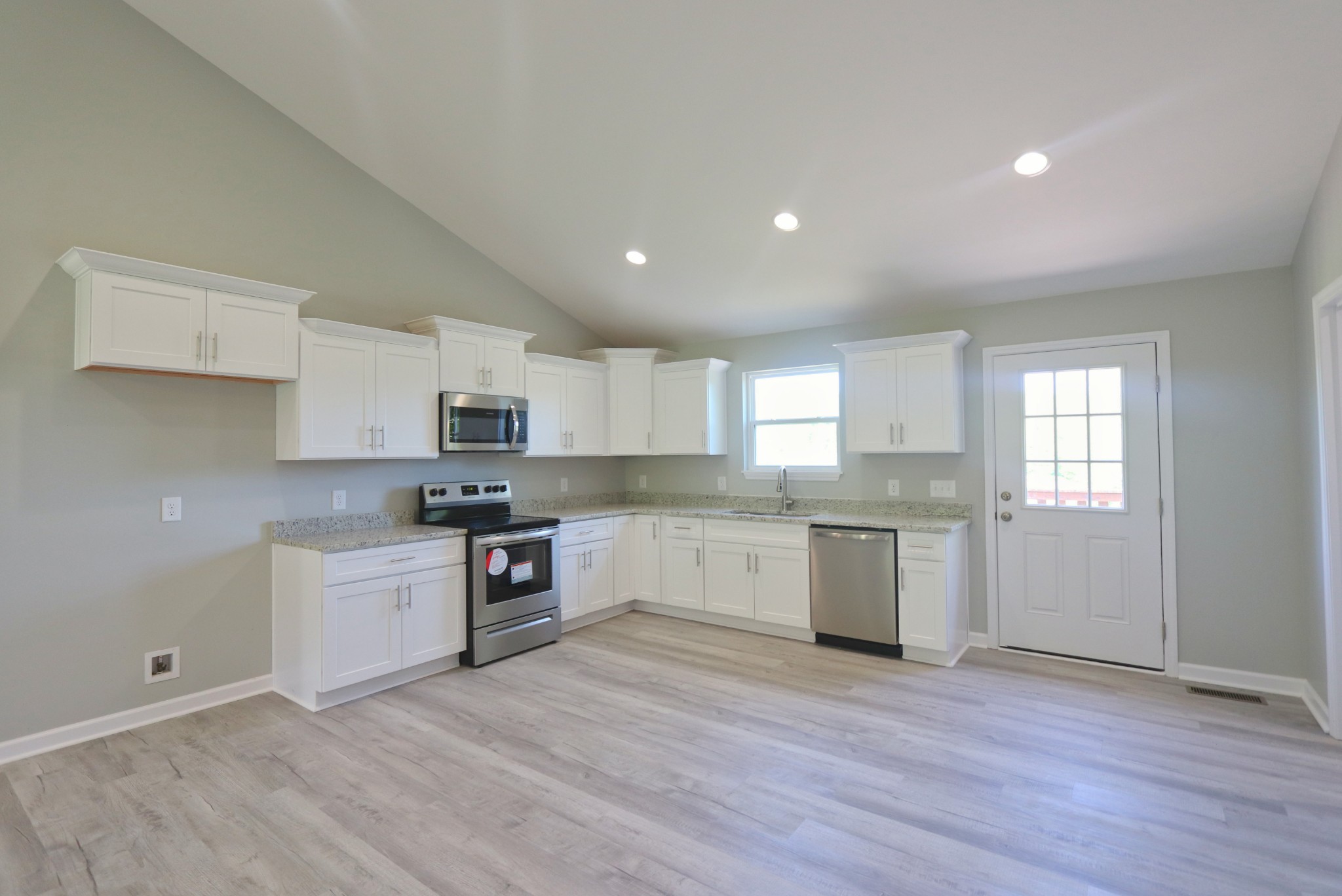 512 Highland Park Road Red Boiling Springs, TN 37150 - Photo 5 of 18 a large kitchen with a white stove top oven and white cabinets