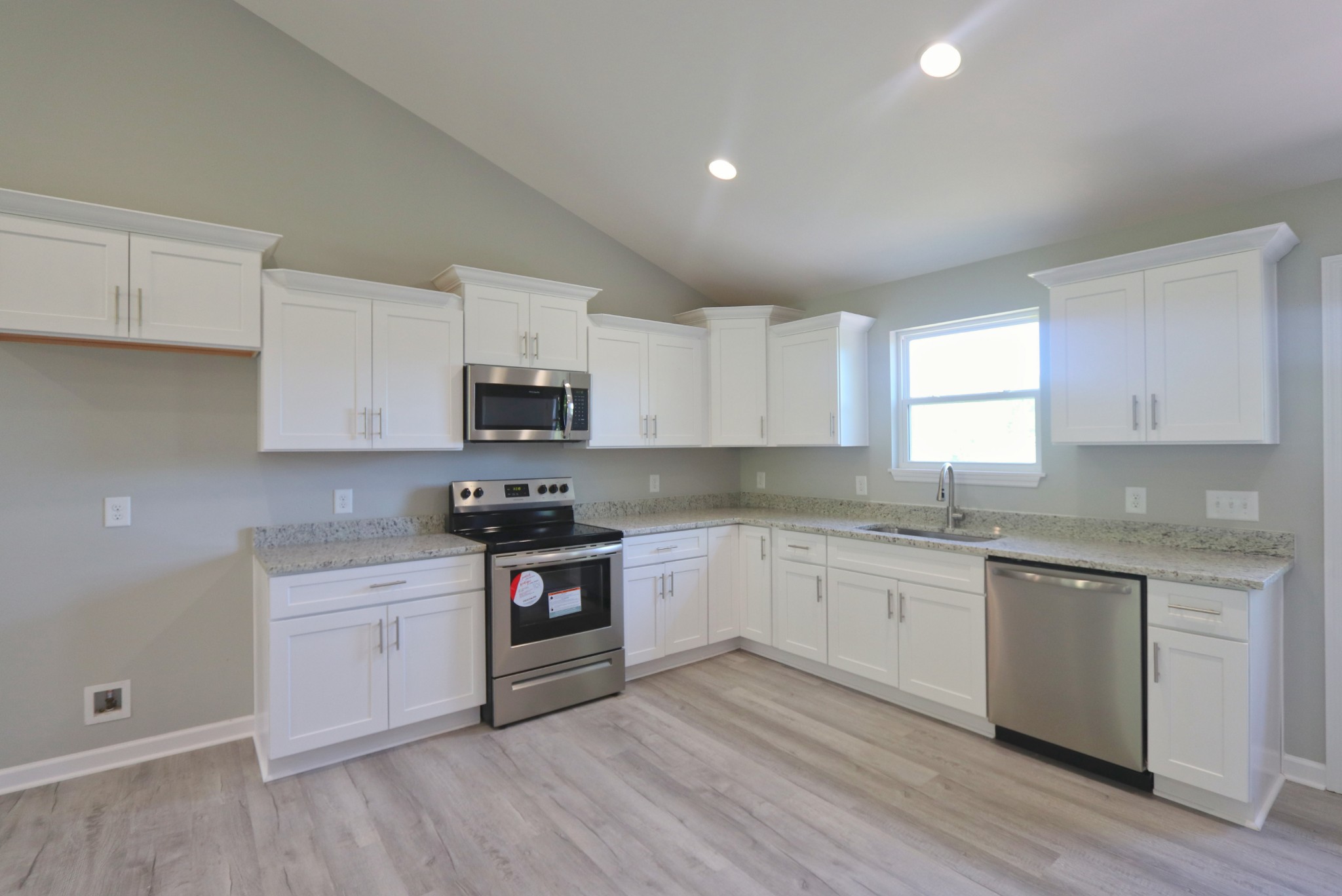 512 Highland Park Road Red Boiling Springs, TN 37150 - Photo 6 of 18 a kitchen with granite countertop white cabinets and appliances