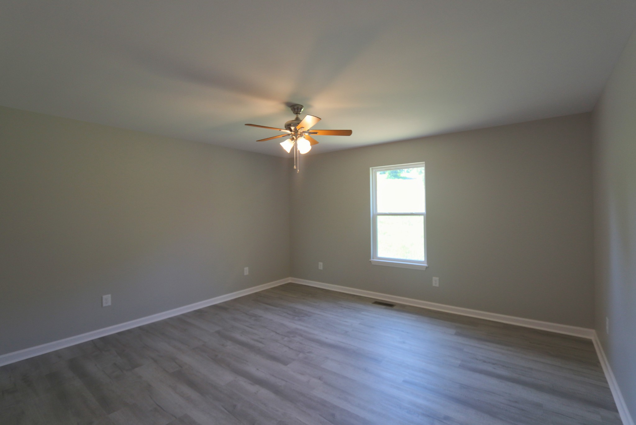 512 Highland Park Road Red Boiling Springs, TN 37150 - Photo 9 of 18 a view of an empty room with wooden floor and a window