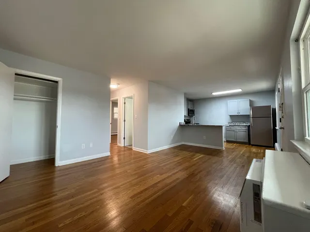 a view of a kitchen with a sink and a refrigerator