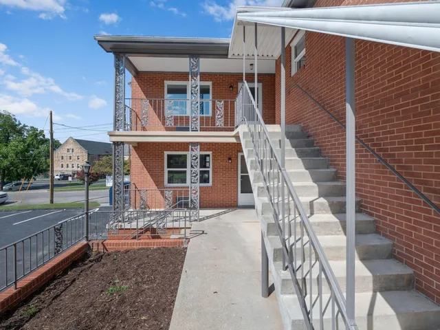 a front view of a house with outdoor seating