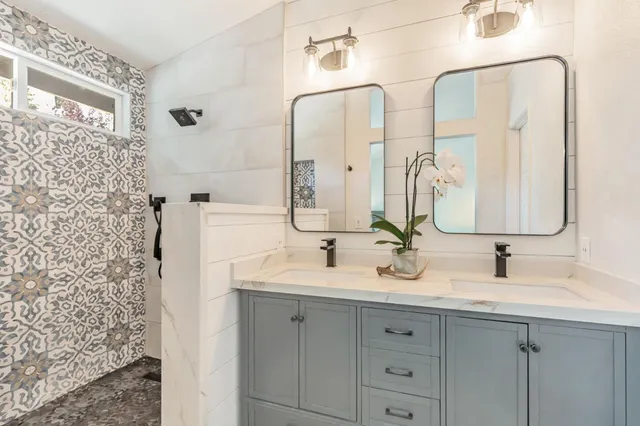 a bathroom with a double vanity sink mirror and