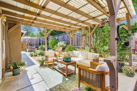 a building outdoor space with patio furniture and potted plants
