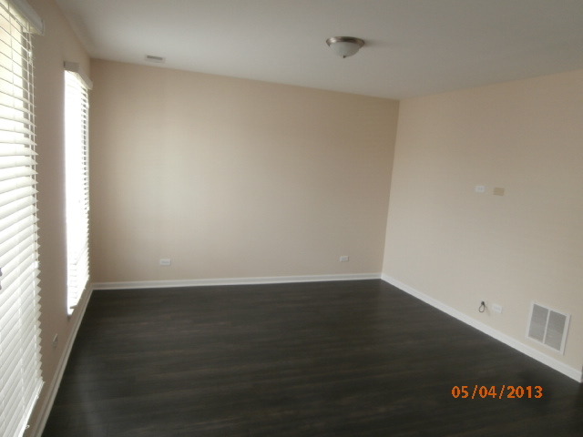 334 Rodenburg Road Roselle, IL 60172 - Photo 3 of 14 an empty room with wooden floor and windows