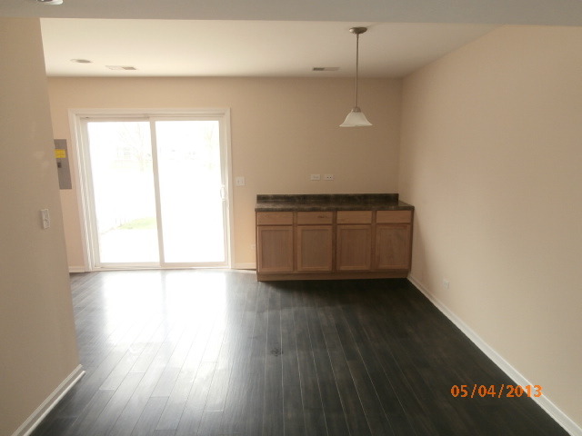 334 Rodenburg Road Roselle, IL 60172 - Photo 5 of 14 an empty room with wooden floor and windows
