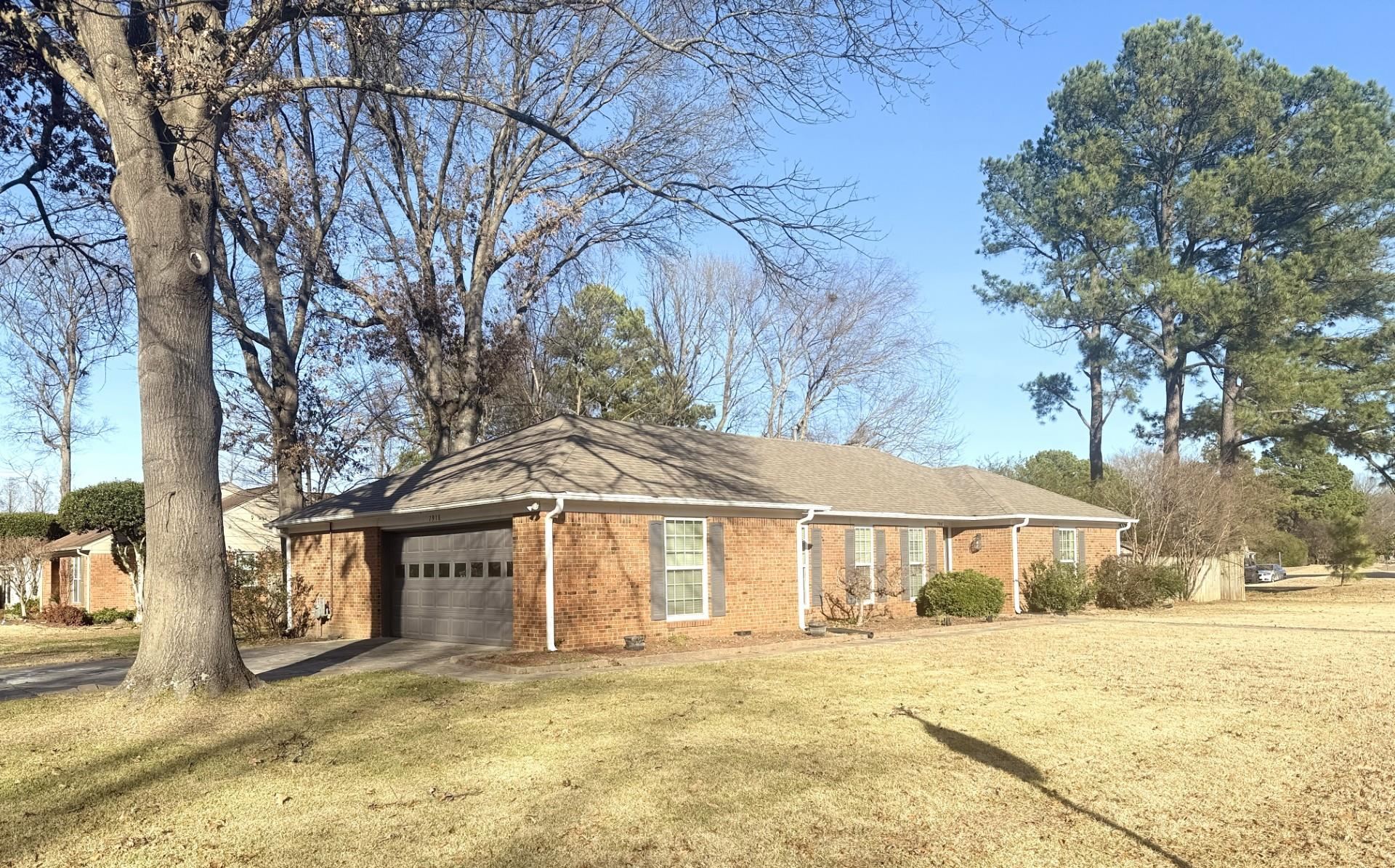 7918 Farmingdale Road Germantown, TN 38138 - Photo 1 of 12 View of front of house with a garage and a front lawn