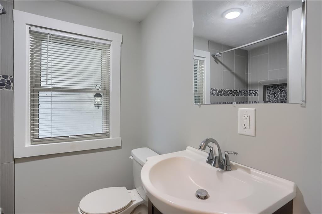 549 Sawmill Run Road Butler, PA 16001 - Photo 18 of 25 a bathroom with a sink mirror and toilet