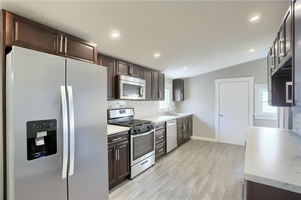 549 Sawmill Run Road Butler, PA 16001 - Photo 8 of 25 a kitchen with stainless steel appliances a refrigerator a stove a sink and a refrigerator