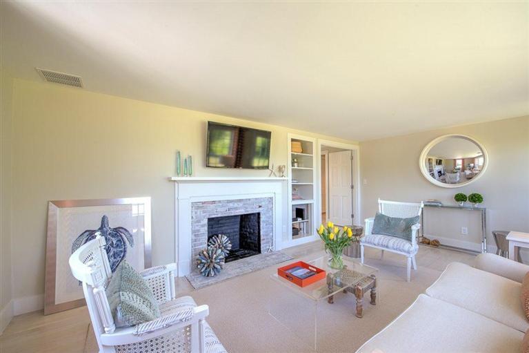 12 Salten Point Road Barnstable, MA 02630 - Photo 12 of 33 a living room with furniture a fireplace and a flat screen tv