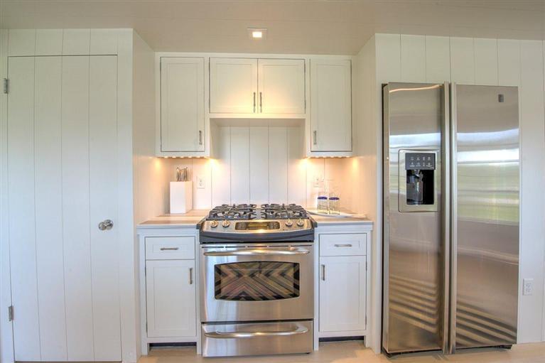 12 Salten Point Road Barnstable, MA 02630 - Photo 7 of 33 a kitchen with a stove and a refrigerator
