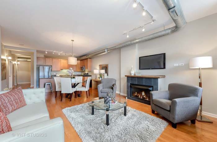 1200 West Monroe Street, Unit 502 Chicago, IL 60607 - Photo 6 of 20 a living room with furniture fireplace and a table