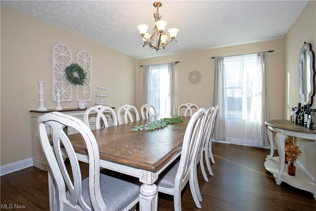 4750 McCauley Road Wooster, OH 44691 - Photo 7 of 37 Dining space with dark floors, a chandelier, and a textured ceiling