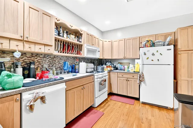 a kitchen with refrigerator and cabinets