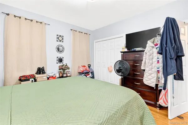 a bedroom with a bed and a tv
