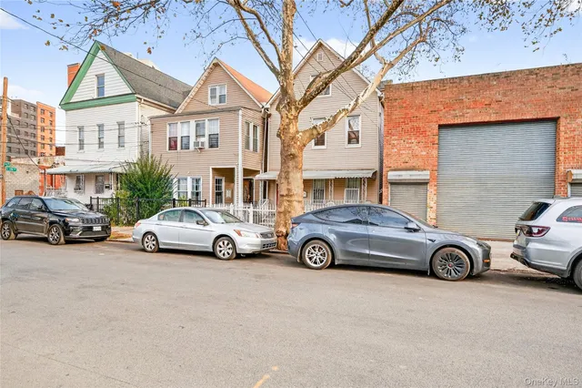 a car parked in front of a white house