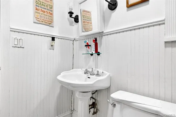 a bathroom with a sink a toilet and shower curtain